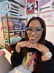 Amanda at home office, surrounded by cool cats and cartoons.