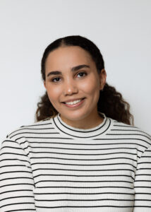 Headshot of Kenli Manning in front of a white wall.