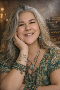 Sheila Madonia Maberry, literary manager, smiling in a warm-toned headshot with silver hair and turquoise jewelry.
